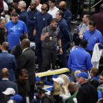 
              Officials help soak up a rain leak from the American Airlines Center roof during the second half of Game 4 of the NBA basketball playoffs Western Conference finals between the Dallas Mavericks and the Golden State Warriors, Tuesday, May 24, 2022, in Dallas. (AP Photo/Tony Gutierrez)
            