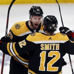 
              Boston Bruins' Charlie Coyle (13) celebrates his goal with Craig Smith (12) during the second period against the Carolina Hurricanes in Game 6 of an NHL hockey Stanley Cup first-round playoff series Thursday, May 12, 2022, in Boston. (AP Photo/Michael Dwyer)
            
