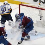 
              Colorado Avalanche defenseman Cale Makar, right front, clears the puck after a stop by goaltender Darcy Kuemper, center, on a shot by St. Louis Blues right wing Vladimir Tarasenko during the first period of Game 5 of an NHL hockey Stanley Cup second-round playoff series Wednesday, May 25, 2022, in Denver. (AP Photo/David Zalubowski)
            