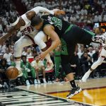 
              Miami Heat forward Jimmy Butler (22) and Boston Celtics forward Grant Williams (12) go after a loose ball 126during the second half of Game 5 of the NBA basketball Eastern Conference finals playoff series, Wednesday, May 25, 2022, in Miami. (AP Photo/Lynne Sladky)
            