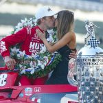 
              Marcus Ericsson, of Sweden, kisses girlfriend Iris Tritsaris Jondahl as they pose with the Borg-Warner Trophy during the traditional winners photo session at Indianapolis Motor Speedway in Indianapolis, Monday, May 30, 2022. Ericsson won the 106th running of the Indianapolis 500 auto race on Sunday. (AP Photo/Michael Conroy)
            