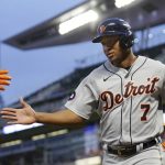 
              Detroit Tigers' Jonathan Schoop celebrates with a teammate after scoring against the Minnesota Twins in the seventh inning of a baseball game Monday, May 23, 2022, in Minneapolis. (AP Photo/Andy Clayton-King)
            