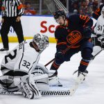 
              Los Angeles Kings goalie Jonathan Quick, left, kicks away a loose puck as Edmonton Oilers right wing Kailer Yamamoto closes in during the second period in Game 7 of a first-round series in the NHL hockey Stanley Cup playoffs Saturday, May 14, 2022, in Edmonton, Alberta. (Jeff McIntosh/The Canadian Press via AP)
            