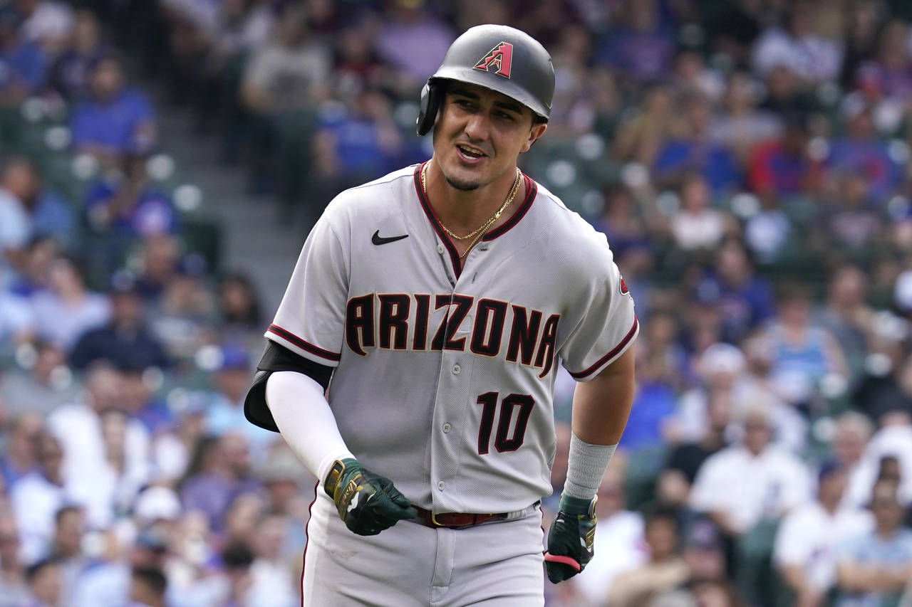 Arizona Diamondbacks' Josh Rojas smiles as he rounds the bases after hitting a solo home run during...