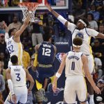 
              Memphis Grizzlies guard Ja Morant (12) is defended by Golden State Warriors forward Otto Porter Jr. (32) and center Kevon Looney (5) during the first half of Game 2 of a second-round NBA basketball playoff series Tuesday, May 3, 2022, in Memphis, Tenn. (AP Photo/Brandon Dill)
            