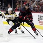 
              Carolina Hurricanes' Jordan Staal (11) controls the puck in front of Boston Bruins' Charlie McAvoy (73) during the second period of Game 5 of an NHL hockey Stanley Cup first-round playoff series in Raleigh, N.C., Tuesday, May 10, 2022. (AP Photo/Karl B DeBlaker)
            