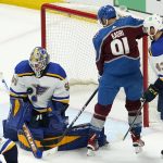 
              St. Louis Blues goaltender Jordan Binnington (50) makes a save against Colorado Avalanche center Nazem Kadri (91) during the first period in Game 2 of an NHL hockey Stanley Cup second-round playoff series Thursday, May 19, 2022, in Denver. (AP Photo/Jack Dempsey)
            
