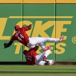 
              Cincinnati Reds' Aristides Aquino (44) catches a ball hit by San Francisco Giants' Tommy La Stella as he collides with teammate Nick Senzel (15) during the seventh inning of a baseball game in Cincinnati, Saturday, May 28, 2022. (AP Photo/Aaron Doster)
            