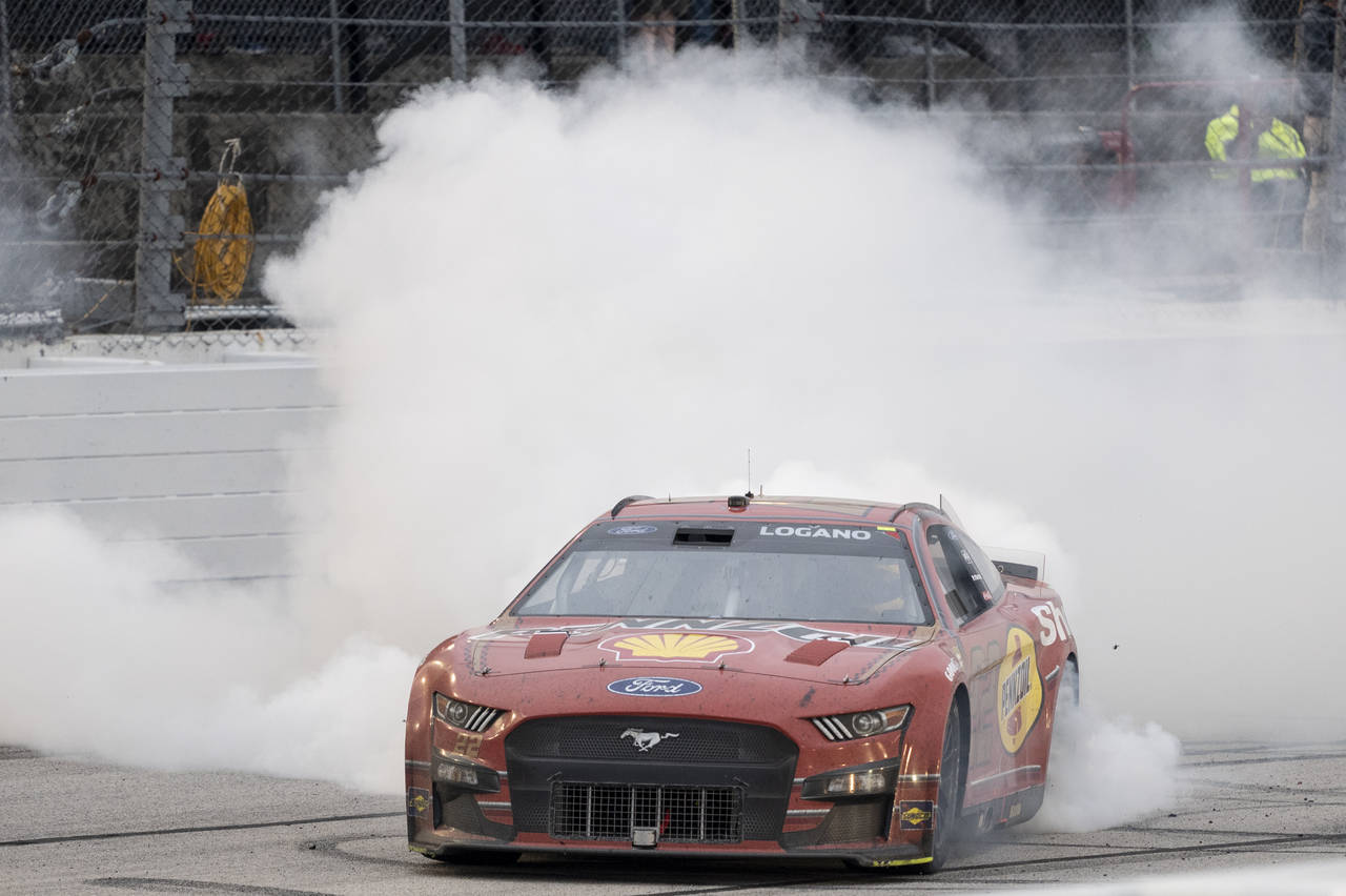Joey Logano celebrates with a burnout after winning a NASCAR Cup Series auto race at Darlington Rac...