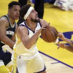 
              Golden State Warriors' Klay Thompson is defended by Memphis Grizzlies' Kyle Anderson and Desmond Bane in the second quarter of Game 4 of an NBA basketball Western Conference playoff semifinal in San Francisco, Monday, May 9, 2022. (Scott Strazzante/San Francisco Chronicle via AP)
            
