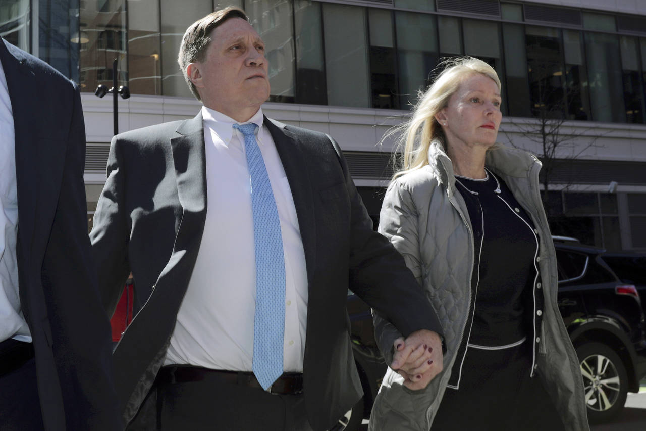 FILE - John Wilson arrives at federal court, with his wife Leslie, on April 3, 2019 to face charges...