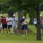 
              Fans watch as Jordan Spieth hits from the rough on the 14th hole during a practice round for the PGA Championship golf tournament, Tuesday, May 17, 2022, in Tulsa, Okla. (AP Photo/Matt York)
            