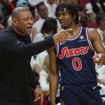 
              Philadelphia 76ers head coach Doc Rivers talks to guard Tyrese Maxey (0) on the sidelines during the first half of Game 1 of an NBA basketball second-round playoff series against the Miami Heat, Monday, May 2, 2022, in Miami. (AP Photo/Marta Lavandier)
            
