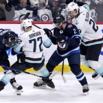 
              Winnipeg Jets' Evgeny Svechnikov (71) and Dylan DeMelo (2) battle Seattle Kraken's Joonas Donskoi (72) for the puck as Kraken's Jamie Oleksiak moves in during the first period of NHL hockey game action in Winnipeg, Manitoba, Sunday, May 1, 2022. (Fred Greenslade/The Canadian Press via AP)
            
