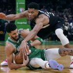 
              Boston Celtics forward Jayson Tatum, left, grabs a loose ball next to Milwaukee Bucks forward Giannis Antetokounmpo during the second half of Game 2 of an Eastern Conference semifinal in the NBA basketball playoffs Tuesday, May 3, 2022, in Boston. (AP Photo/Charles Krupa)
            