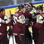 
              Latvia players celebrate after winning the 2022 IIHF Ice Hockey World Championships preliminary round group B match between Latvia and Norway in Tampere, Finland, Monday May 16, 2022. (Vesa Moilanen/Lehtikuva via AP)
            