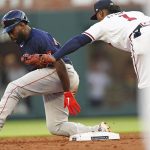 
              Boston Red Sox' Jackie Bradley Jr. (19) is tagged out by Atlanta Braves second baseman Ozzie Albies (1) as he tries to steal second base in the third inning of a baseball game Wednesday, May 11, 2022, in Atlanta. (AP Photo/John Bazemore)
            
