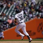 
              Detroit Tigers' Harold Castro signals as he rounds the bases after a solo home run during the fourth inning of a baseball game against the Cleveland Guardians, Sunday, May 29, 2022, in Detroit. (AP Photo/Carlos Osorio)
            