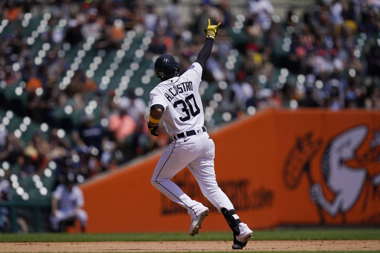Detroit Tigers' Harold Castro signals as he rounds the bases after a solo home run during the fourt...