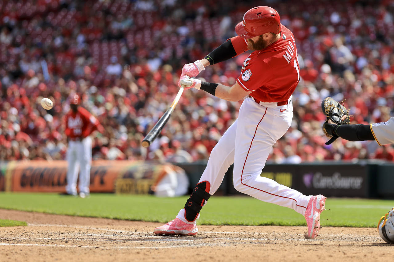 Cincinnati Reds' Colin Moran hits a grand slam during the sixth inning of a baseball game against t...