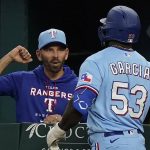 
              Texas Rangers manager Chris Woodward, left, meets Adolis Garcia at the dugout after Garcia hit a two run homer during the sixth inning of a baseball game against the Boston Red Sox in Arlington, Texas, Sunday, May 15, 2022. Rangers Corey Seager also scored on the play. (AP Photo/LM Otero)
            