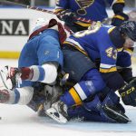 
              Colorado Avalanche's Nazem Kadri, left, falls on St. Louis Blues goaltender Jordan Binnington behind teammate Calle Rosen (43) during the first period in Game 3 of an NHL hockey Stanley Cup second-round playoff series Saturday, May 21, 2022, in St. Louis. Binnington was injured on the play and left the game. (AP Photo/Jeff Roberson)
            