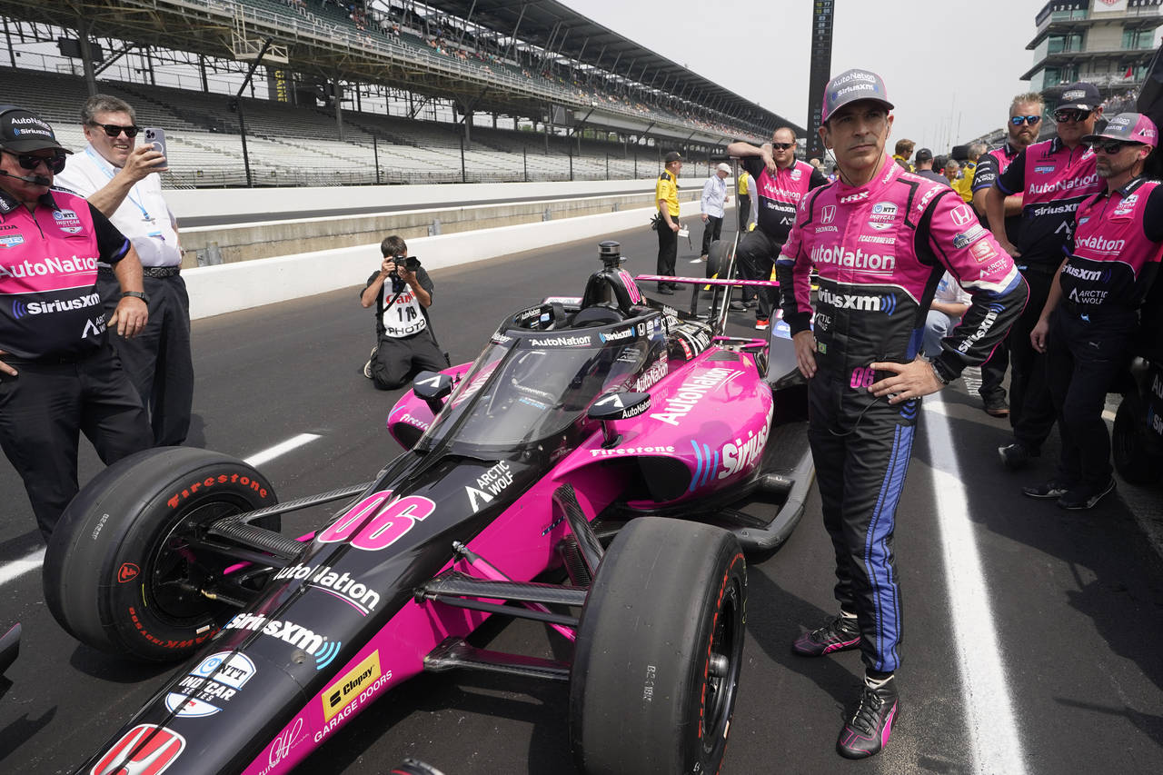 Helio Castroneves, of Brazil, stands by his car during qualifications for the Indianapolis 500 auto...