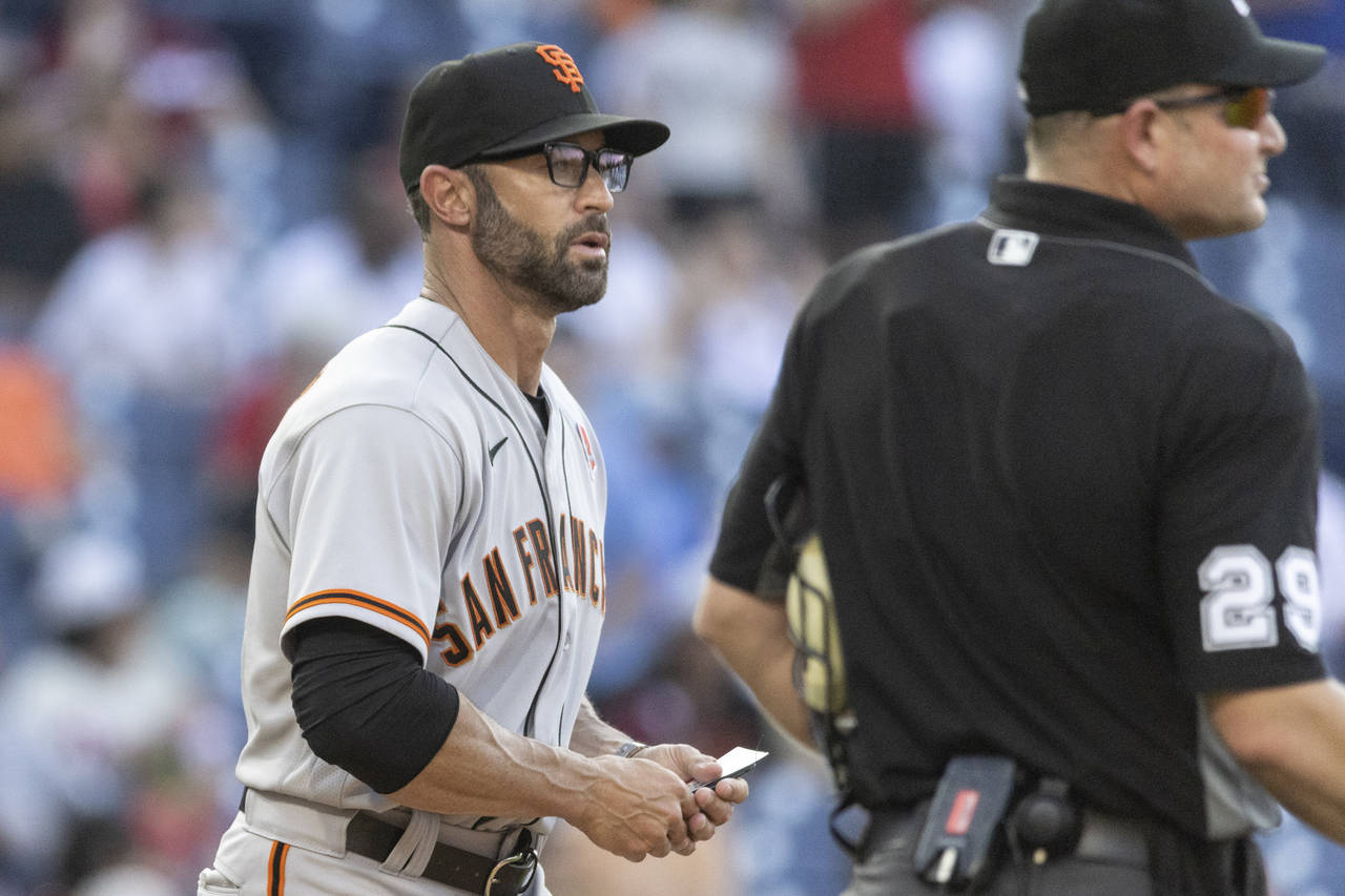 San Francisco Giants manager Gabe Kapler, left, approaches the mound during the ninth inning of a b...