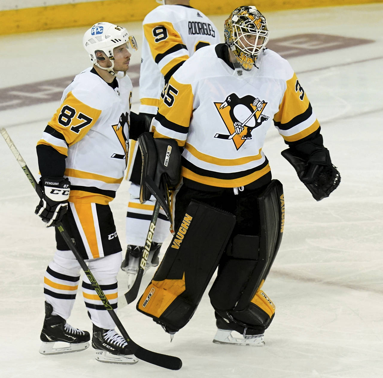 Pittsburgh Penguins center Sidney Crosby and goaltender Tristan Jarry skate off the ice after losin...