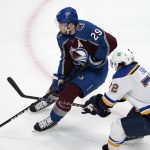 
              Colorado Avalanche center Nathan MacKinnon, left, drives to the net with St. Louis Blues defenseman Justin Faulk in pursuit during the first period of Game 5 of an NHL hockey Stanley Cup second-round playoff series Wednesday, May 25, 2022, in Denver. (AP Photo/David Zalubowski)
            