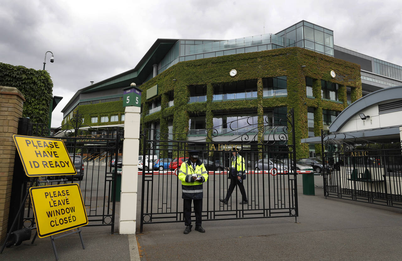 FILE - Security guards are shown at the gate in front of Centre Court at the All England Lawn Tenni...