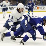 
              Toronto Maple Leafs defenseman Justin Holl (3) takes down Tampa Bay Lightning left wing Brandon Hagel (38) during the second period in Game 4 of an NHL hockey first-round playoff series Sunday, May 8, 2022, in Tampa, Fla. (AP Photo/Chris O'Meara)
            