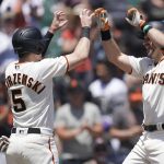 
              San Francisco Giants' Evan Longoria, right, celebrates after hitting a three-run home run that scored Wilmer Flores, left, and Mike Yastrzemski (5) during the first inning of a baseball game against the New York Mets in San Francisco, Wednesday, May 25, 2022. (AP Photo/Jeff Chiu)
            