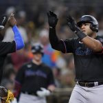 
              Miami Marlins' Jesus Aguilar, right, reacts with teammate Jazz Chisholm Jr. (2) after hitting a two-run home run during the sixth inning of a baseball game against the San Diego Padres, Friday, May 6, 2022, in San Diego. (AP Photo/Gregory Bull)
            