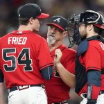 
              Atlanta Braves pitching coach Rick Kranitz, center, talks with pitcher Max Fried (54) and catcher Travis d'Arnaud, right, during the sixth inning of a baseball game against the San Diego Padres, Friday, May 13, 2022, in Atlanta. (AP Photo/John Bazemore)
            