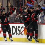 
              Carolina Hurricanes' Andrei Svechnikov, right, celebrates his goal against the New York Rangers with Martin Necas (88) and Vincent Trocheck (16) during the third period of Game 5 of an NHL hockey Stanley Cup second-round playoff series in Raleigh, N.C., Thursday, May 26, 2022. (AP Photo/Karl B DeBlaker)
            