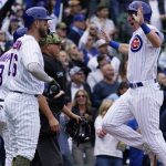 
              Chicago Cubs' Frank Schwindel, right, celebrates with Patrick Wisdom and Ian Happ after scoring on a three-run triple by P.J. Higgins against the Arizona Diamondbacks during the second inning of a baseball game in Chicago, Sunday, May 22, 2022. (AP Photo/Nam Y. Huh)
            