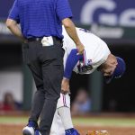 
              Texas Rangers starting pitcher Martin Perez, right, is checked on by head athletic trainer Matt Lucero, left, after Perez was hit in the lower right leg by a ball on a hit by Tampa Bay Rays' Taylor Walls in the second inning of a baseball game, Tuesday, May 31, 2022, in Arlington, Texas. Perez continued playing in the game. (AP Photo/Tony Gutierrez)
            