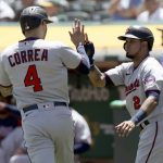 
              Minnesota Twins' Luis Arraez (2) congratulates Carlos Correa (4) after they score in the first inning of a baseball game in Oakland, Calif., on Wednesday, May 18, 2022. (AP Photo/Scot Tucker)
            