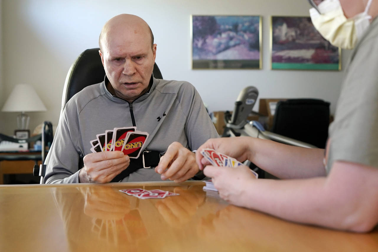 Former Detroit Red Wings star Vladimir Konstantinov plays Uno with health care provider Angela Mart...