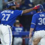 
              Toronto Blue Jays' Alejandro Kirk (30) is congratulated by Vladimir Guerrero Jr. (27) after scoring against the New York Yankees during the fifth inning of a baseball game Tuesday, May 3, 2022, in Toronto. (Nathan Denette/The Canadian Press via AP)
            