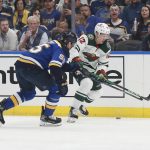 
              Minnesota Wild's Matt Boldy (12) works the puck against St. Louis Blues' Colton Parayko (55) during the first period in Game 6 of an NHL hockey Stanley Cup first-round playoff series Thursday, May 12, 2022, in St. Louis. (AP Photo/Michael Thomas)
            