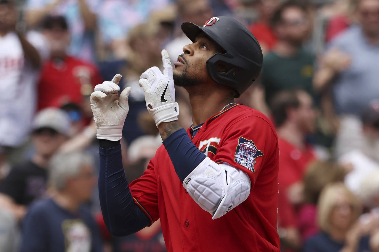 Minnesota Twins' Byron Buxton reacts after hitting a home run during the fifth inning of a baseball...