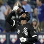 
              Chicago White Sox's Luis Robert celebrates after hitting a two-run home run during the tenth inning of a baseball game against the Kansas City Royals Monday, May 16, 2022, in Kansas City, Mo. (AP Photo/Charlie Riedel)
            