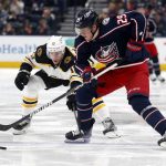 
              Columbus Blue Jackets forward Patrik Laine, right, reaches for the puckin front of Boston Bruins forward Charlie Coyle during the second period of an NHL hockey game in Columbus, Ohio, Monday, April 4, 2022. (AP Photo/Paul Vernon)
            