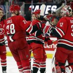 
              Carolina Hurricanes goaltender Antti Raanta (32) is celebrates with teammates Vincent Trocheck, center, Ian Cole (28) and Sebastian Aho (20) after the team's win over the New Jersey Devils in an NHL hockey game in Raleigh, N.C., Thursday, April 28, 2022. (AP Photo/Karl B DeBlaker)
            