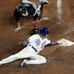 
              Kansas City Royals' Nicky Lopez beats the tag by Chicago White Sox catcher Yasmani Grandal to score on a two-run double by Whit Merrifield during the eighth inning of a baseball game Monday, May 16, 2022, in Kansas City, Mo. (AP Photo/Charlie Riedel)
            