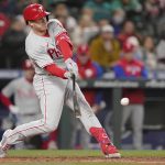 
              Philadelphia Phillies' J.T. Realmuto hits an RBI-single to score Bryce Harper during the fifth inning of a baseball game against the Seattle Mariners, Monday, May 9, 2022, in Seattle. (AP Photo/Ted S. Warren)
            