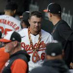 
              Baltimore Orioles' Ryan Mountcastle wears a chain in the dugout after hitting a solo home run against the Minnesota Twins during the second inning of a baseball game, Thursday, May 5, 2022, in Baltimore. (AP Photo/Julio Cortez)
            