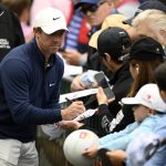 
              Rory McIlroy, of North Ireland, signs autographs after finishing his play in the first round of the Wells Fargo Championship golf tournament, Thursday, May 5, 2022, at TPC Potomac at Avenel Farm golf club in Potomac, Md. (AP Photo/Nick Wass)
            